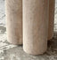 Minimalist round travertine marble table with dual cylindrical legs