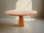 Dario round red travertine dining table