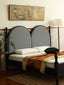 Black and white gingham headboard with double arches and dark wooden frame