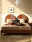 Wooden platform bed with dual circular rattan headboard panels