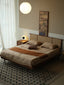 Mid-century platform bed with woven rattan headboard and walnut frame