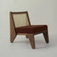 Cane-back armchair with boucle seat.