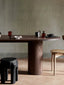 Dark wooden oval dining table with minimalist design