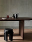 Dark wooden oval dining table with minimalist design