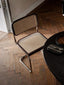 Modern Rattan Chair: Stylish chair with rattan seat, wood details, and metal frame.