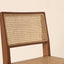 Walnut wood stool with handwoven rattan seat and backrest.