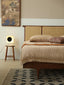 Mid-century platform bed with woven rattan headboard and walnut frame