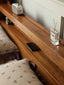 Cherry wood platform bed with tapered legs and built-in shelf headboard