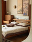 Cherry wood platform bed with tapered legs and built-in shelf headboard