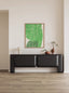 Minimalist black console cabinet with rounded edges against beige wall