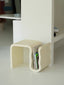 Cream ModCurve organizer with curved design holding magazines