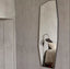 Tall asymmetric frameless mirror with angular design