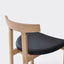 Japanese-inspired solid wood high stool with a sleek design.