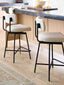 Black metal counter stools with beige fabric upholstery