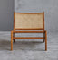 Modern rattan chair with ergonomic wooden frame.