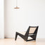 Modern low lounge chair with sleek wood and cane design.