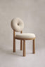 Modern chair with circular tufted backrest.