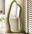 Freestanding green mirror with organic amoeba-shaped frame