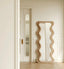 Full-length wooden mirror with wavy, undulating frame design